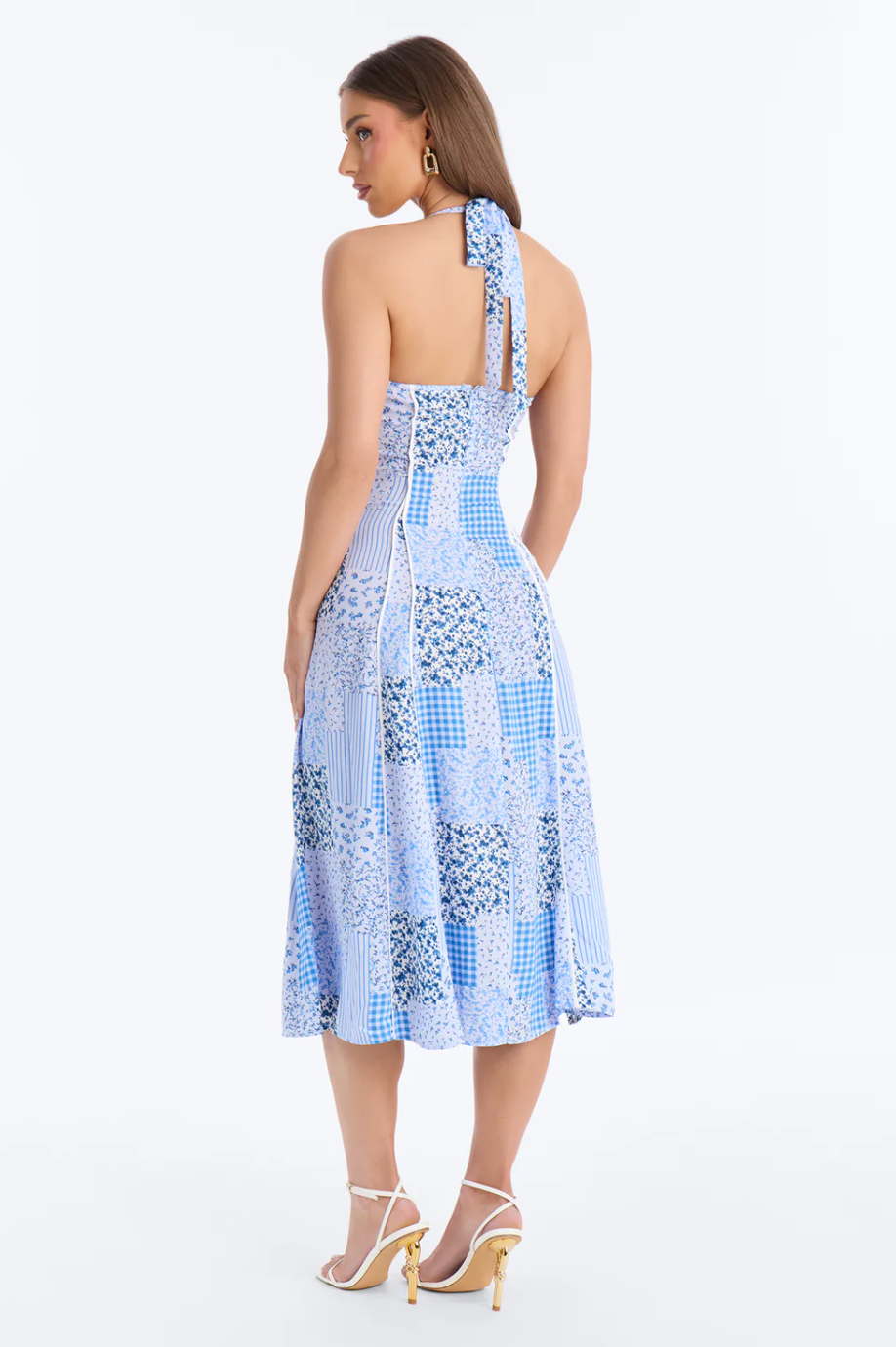 Woman wearing a blue patterned dress on a white background
